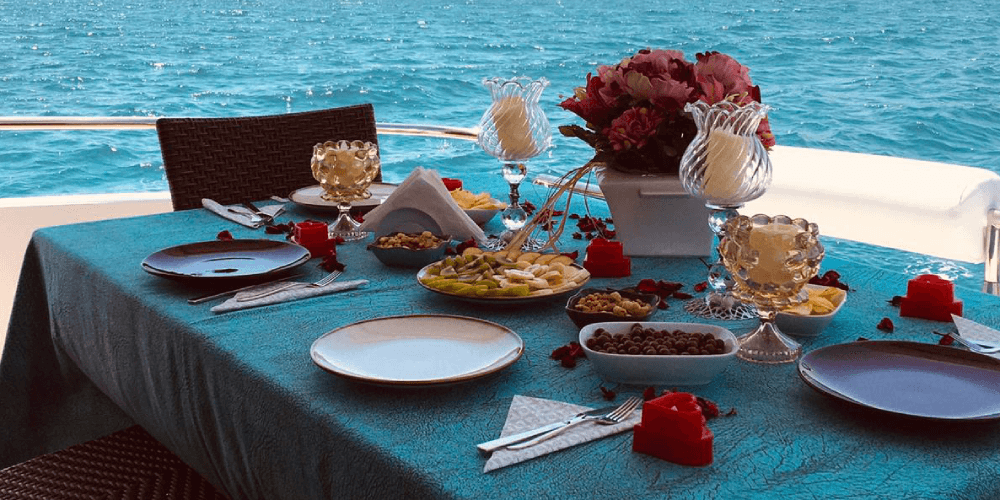 Private yacht setup for birthday dinner with candles and tableware