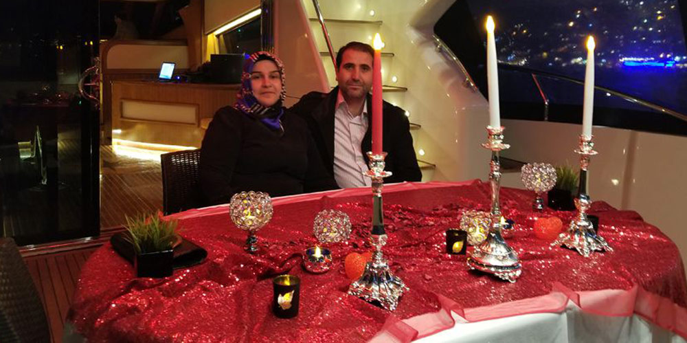Couple enjoying romantic private yacht cruise with dinner on Bosphorus