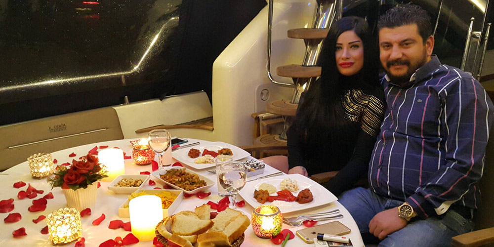 Couple enjoying candlelit dinner on private yacht on the Bosphorus
