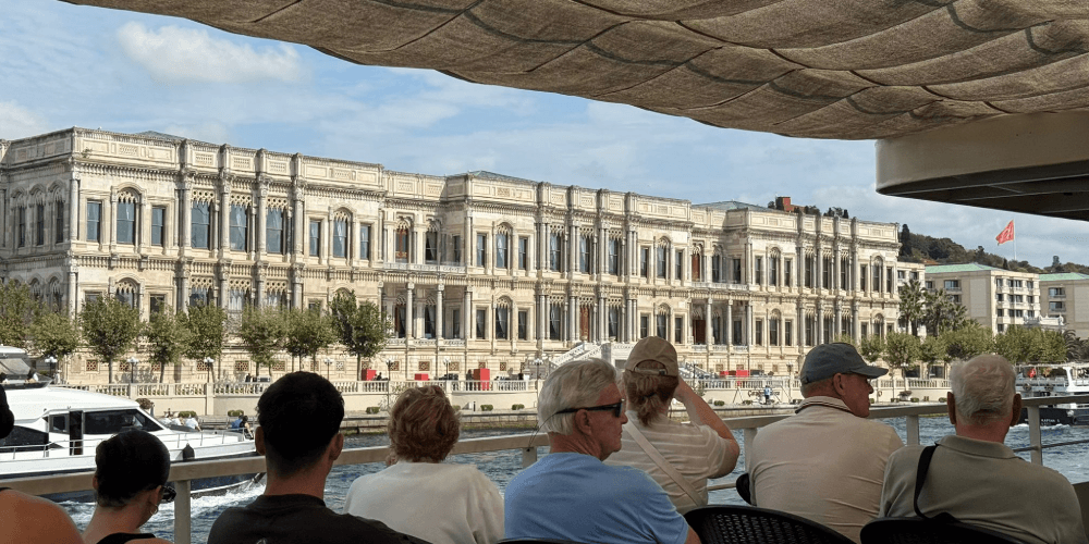 Tourists enjoying open deck views on Istanbul Bosphorus sightseeing cruise